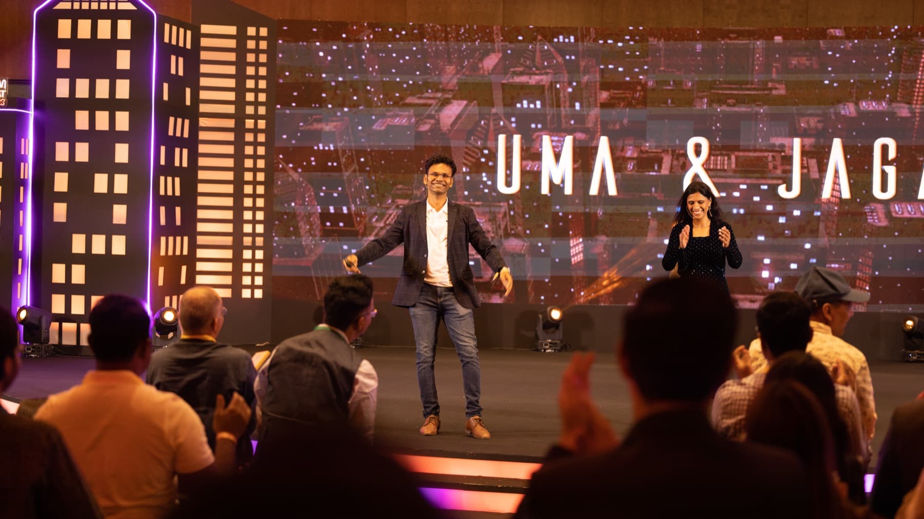 Dr. Uma and Jagan on stage at a live event