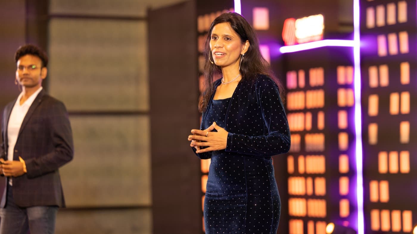 Dr. Uma speaking on stage