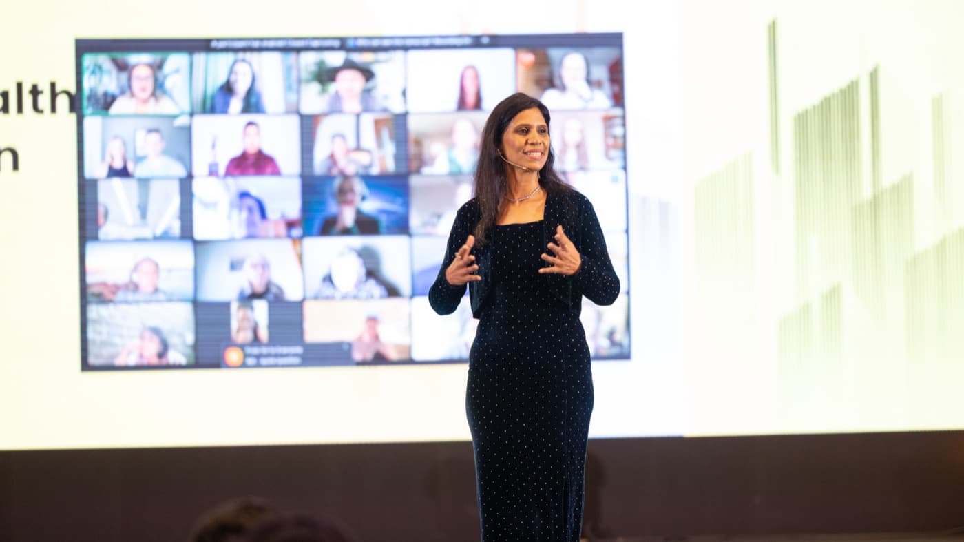 Dr. Uma presenting on stage